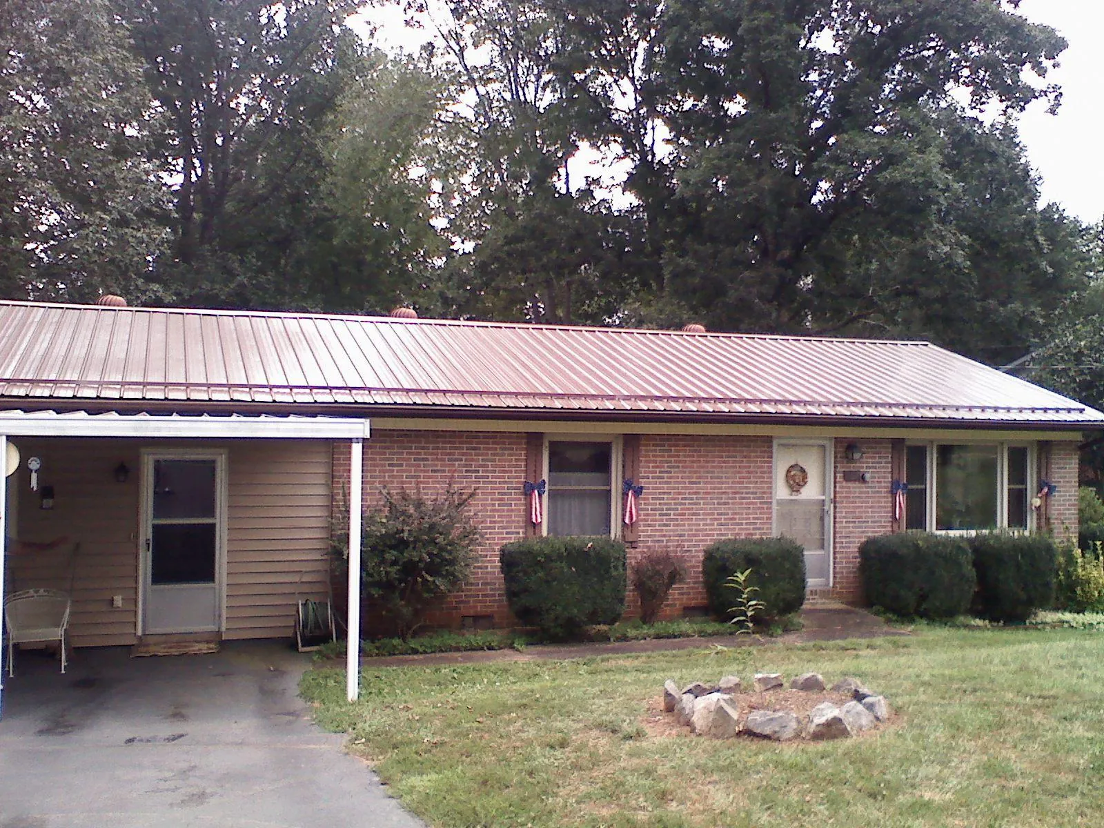 Bronze metal roof and carport on a brick ranch home — Roof Repair work by our crew in Irvine