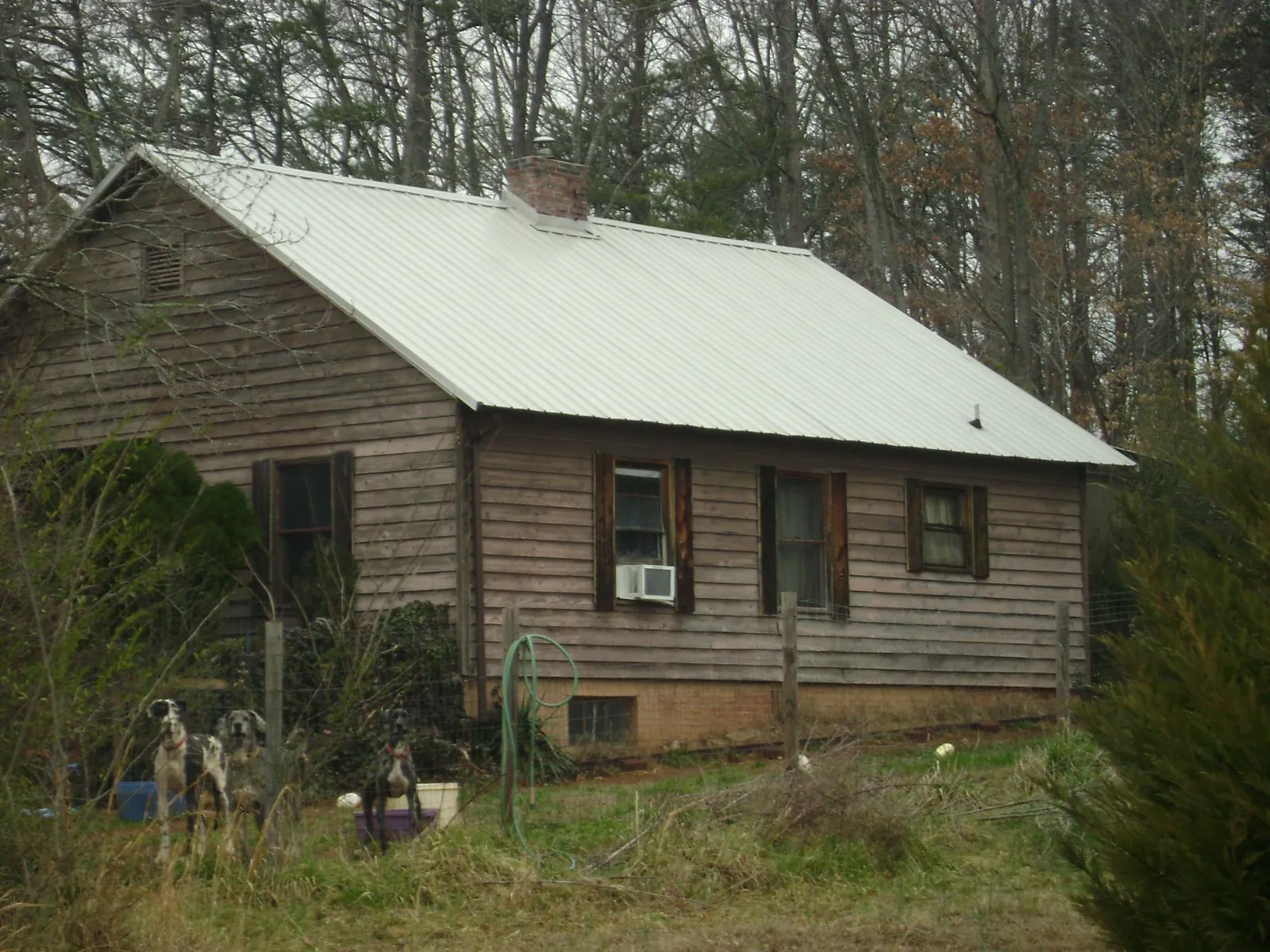 White metal roof on an old wood sided farmhouse, from a Asphalt Shingle Roof Repair job in Irvine